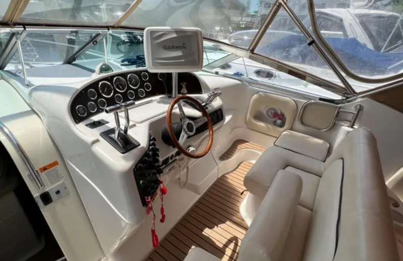 Slide: The Image of 2004 Chris-Craft 33 Express boat cockpit with steering wheel and Garmin navigation system. - 14