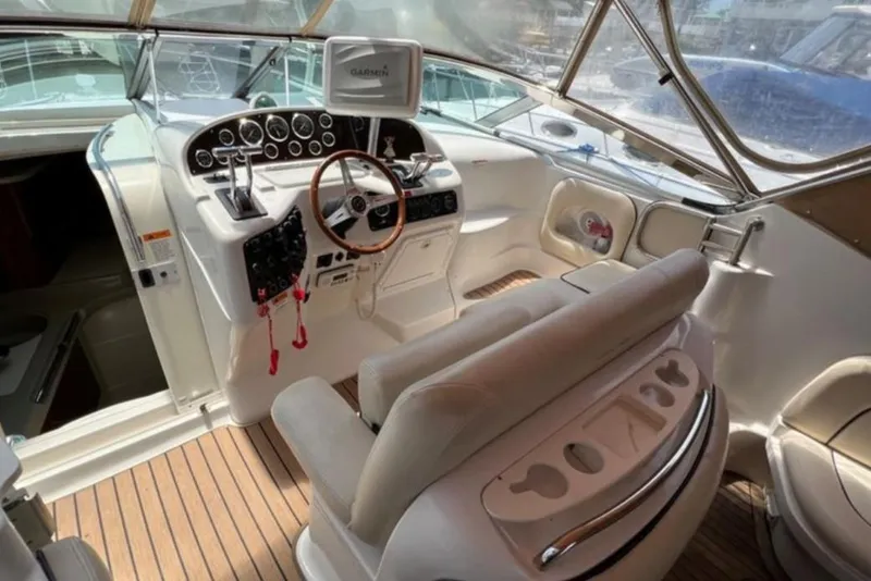 Slide: The Image of 2004 Chris-Craft 33 Express boat cockpit with steering wheel and control panel. - 15