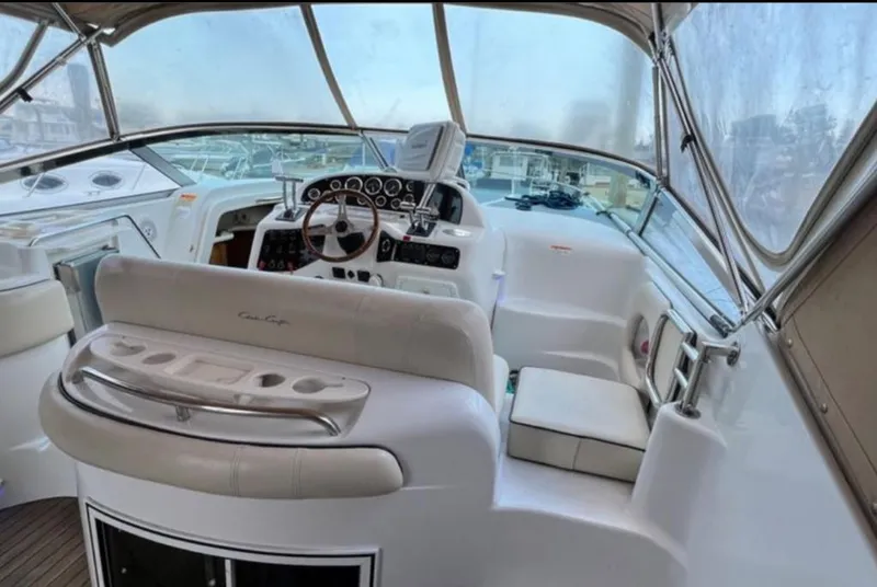Slide: The Image of Interior view of 2004 Chris-Craft 33 Express boat cockpit with steering wheel and seating. - 16