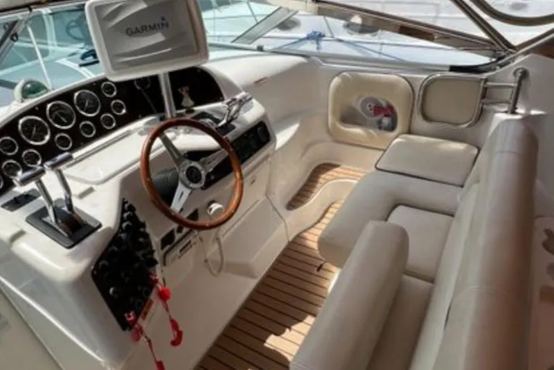 Slide: The Image of 2004 Chris-Craft 33 Express boat interior with steering wheel and Garmin navigation system. - 17
