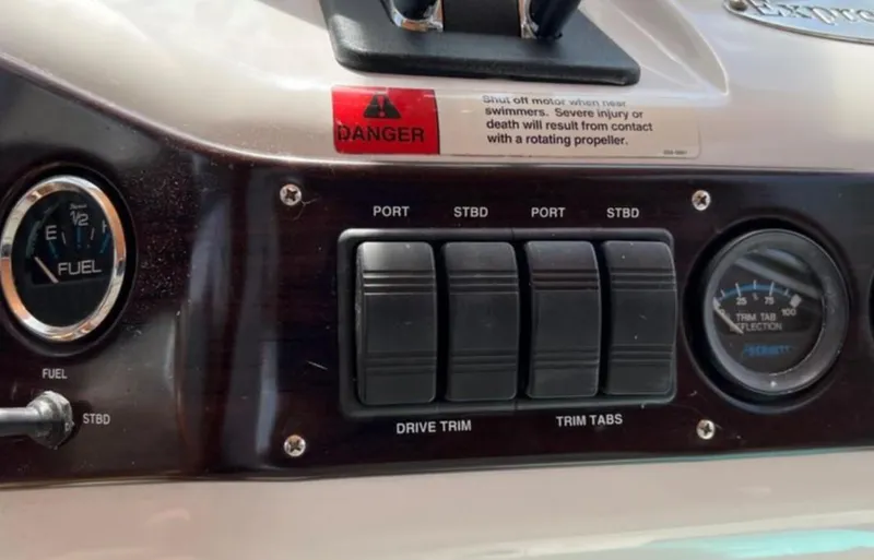 Slide: The Image of Control panel of a 2004 Chris-Craft 33 Express boat with fuel and trim gauges. - 22