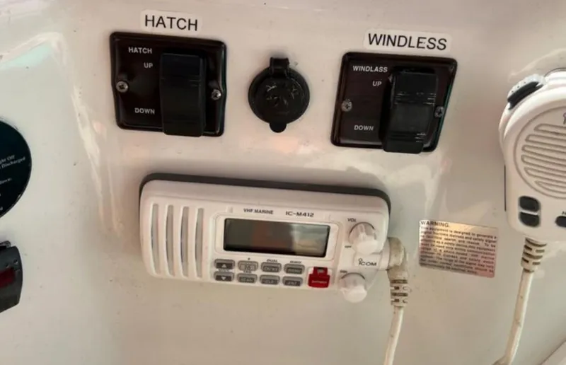 Slide: The Image of Control panel of a 2004 Chris-Craft 33 Express boat with VHF marine radio. - 24