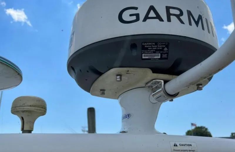 Slide: The Image of Garmin marine radar scanner on 2004 Chris-Craft 33 Express boat under blue sky. - 25
