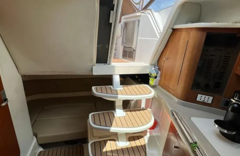 Slide: The Image of Interior of 2004 Chris-Craft 33 Express boat with wooden steps and kitchenette. - 26