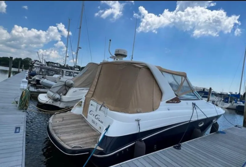Slide: The Image of 2004 Chris-Craft 33 Express docked at marina under blue sky. - 3