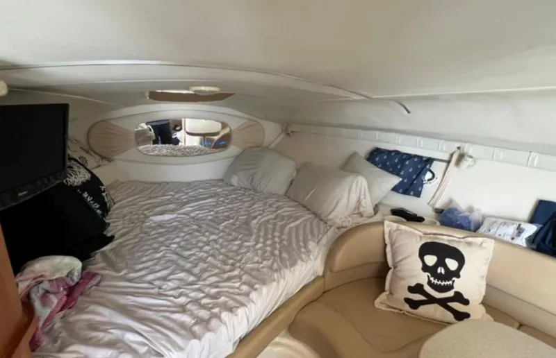 Slide: The Image of Interior of 2004 Chris-Craft 33 Express boat with cozy bed and skull-themed decor. - 37