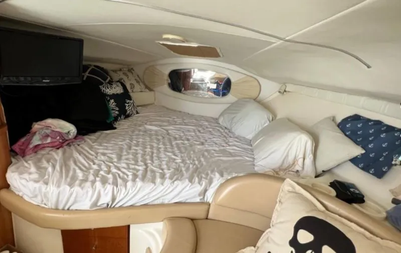 Slide: The Image of Cozy cabin interior of 2004 Chris-Craft 33 Express with bed and TV. - 38