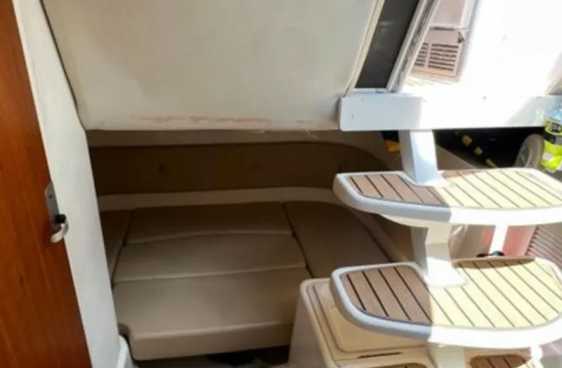 Slide: The Image of 2004 Chris-Craft 33 Express cabin interior with wooden steps and seating area. - 40