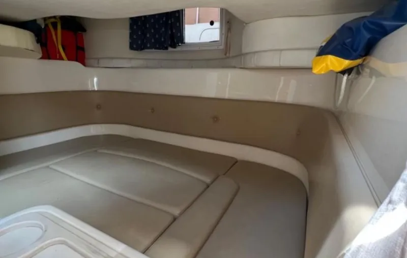 Slide: The Image of 2004 Chris-Craft 33 Express cabin interior with beige seating and storage compartments. - 41