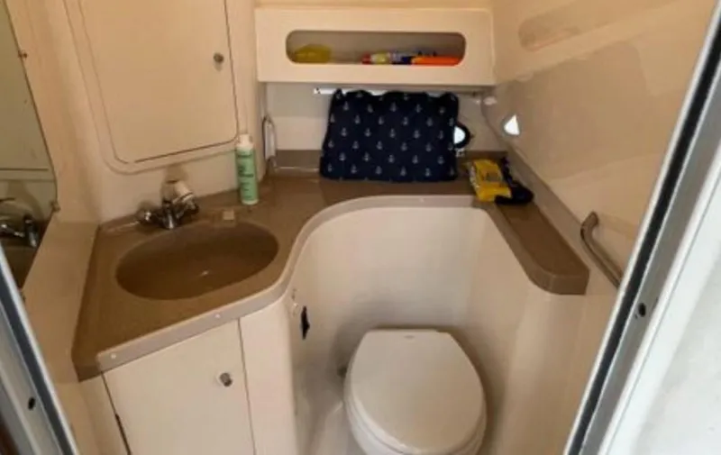 Slide: The Image of Bathroom interior of 2004 Chris-Craft 33 Express boat, featuring sink and toilet. - 46