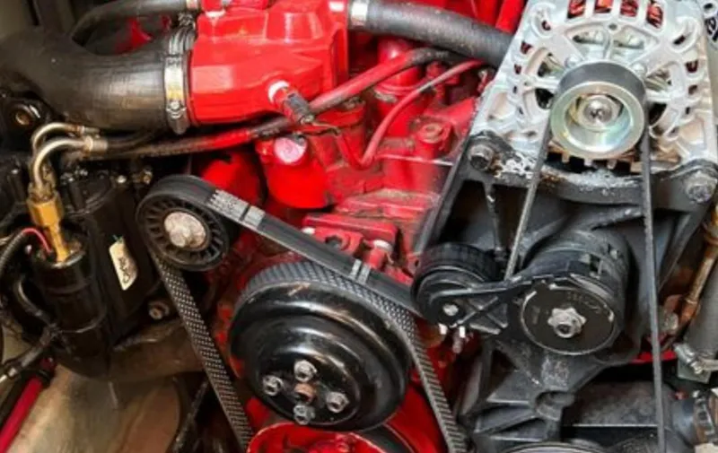 Slide: The Image of Engine components of a 2004 Chris-Craft 33 Express boat, featuring belts and pulleys. - 47