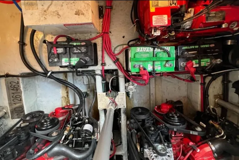 Slide: The Image of Engine room of 2004 Chris-Craft 33 Express with batteries and wiring visible. - 49
