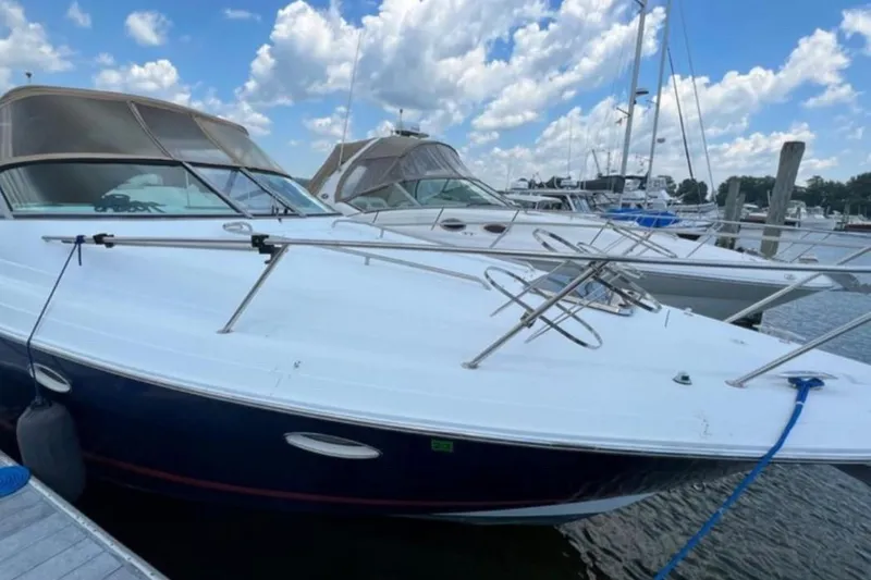 Slide: The Image of 2004 Chris-Craft 33 Express boat docked at marina under blue sky. - 5