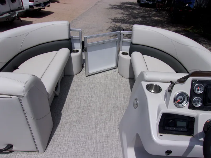 Slide: The Image of 2022 Avalon VLS Quad Lounger boat interior with plush seating and modern dashboard. - 11