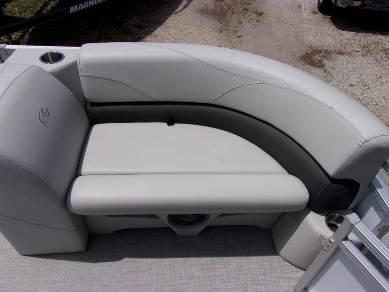 Slide: The Image of 2022 Avalon VLS Quad Lounger boat seat, gray upholstery, curved design, cup holder, outdoor setting. - 12