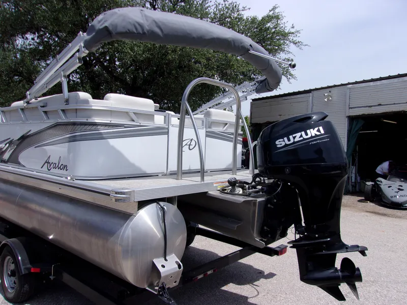 Slide: The Image of 2022 Avalon VLS Quad Lounger 18' pontoon boat with Suzuki outboard motor. - 3