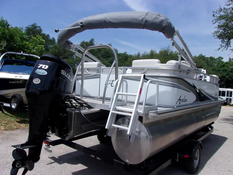 Slide: The Image of 2022 Avalon VLS Quad Lounger pontoon boat with Suzuki 70 engine on trailer. - 4