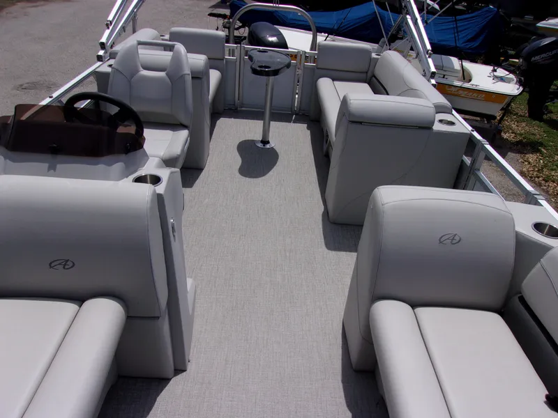 Slide: The Image of 2022 Avalon VLS Quad Lounger boat interior with gray seating and steering console. - 5