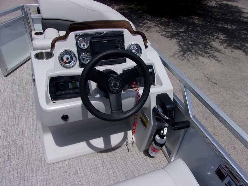 Slide: The Image of 2022 Avalon VLS Quad Lounger boat dashboard with steering wheel and controls. - 6
