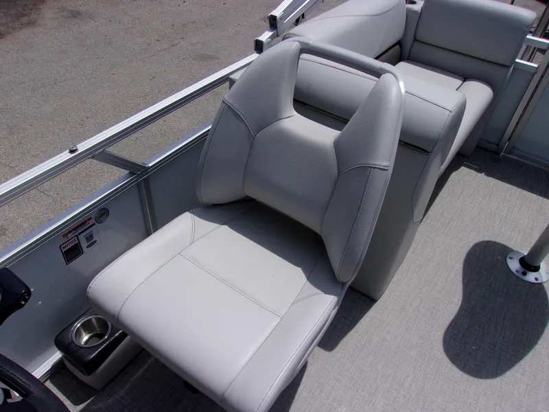 Slide: The Image of 2022 Avalon VLS Quad Lounger boat interior with gray seating and cup holder. - 7