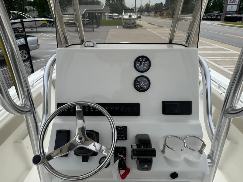 Slide: The Image of Center console of 2025 Key West 239 FS boat with steering wheel and controls. - 11