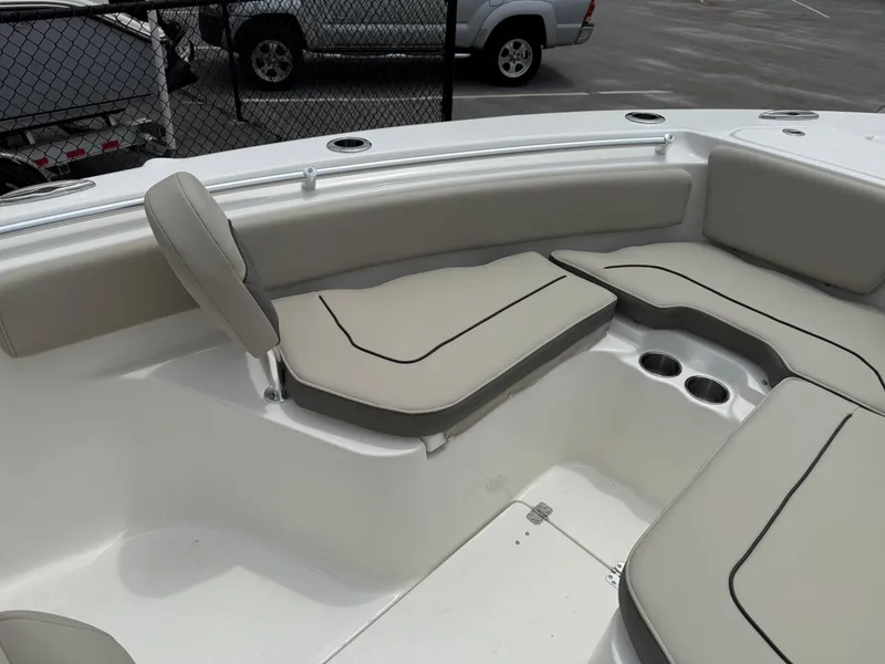 Slide: The Image of 2025 Key West 239 FS boat interior with cushioned seating and cup holders. - 14