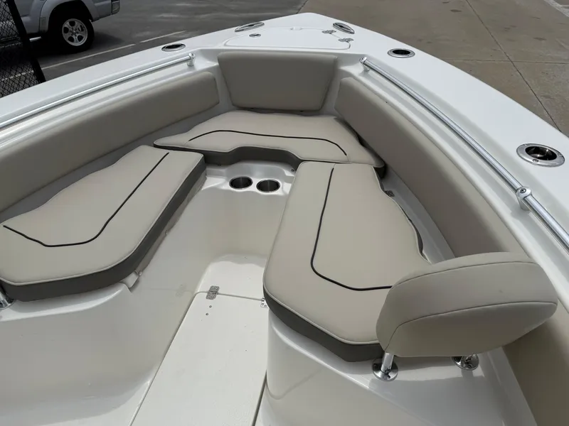 Slide: The Image of 2025 Key West 239 FS boat interior with cushioned seating and cup holders. - 15
