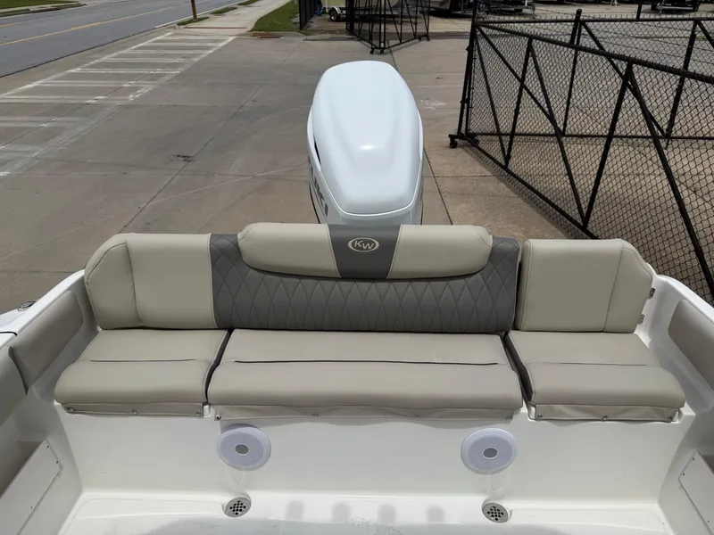 Slide: The Image of 2025 Key West 239 FS boat with cushioned seating and dual speakers. - 20