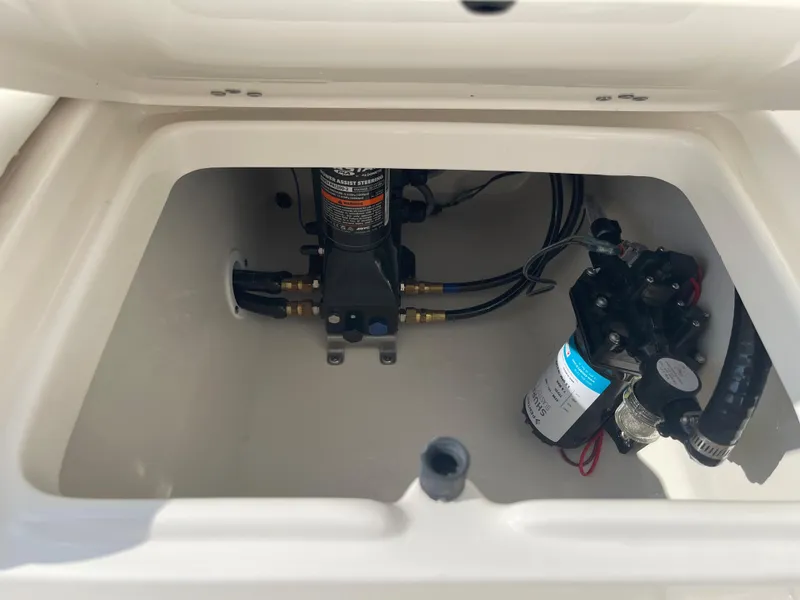 Slide: The Image of 2025 Key West 239 FS boat compartment with pump and wiring components. - 22