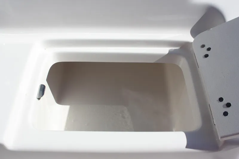 Slide: The Image of Key West 239 FS 2025 boat storage compartment, open lid, white interior. - 24