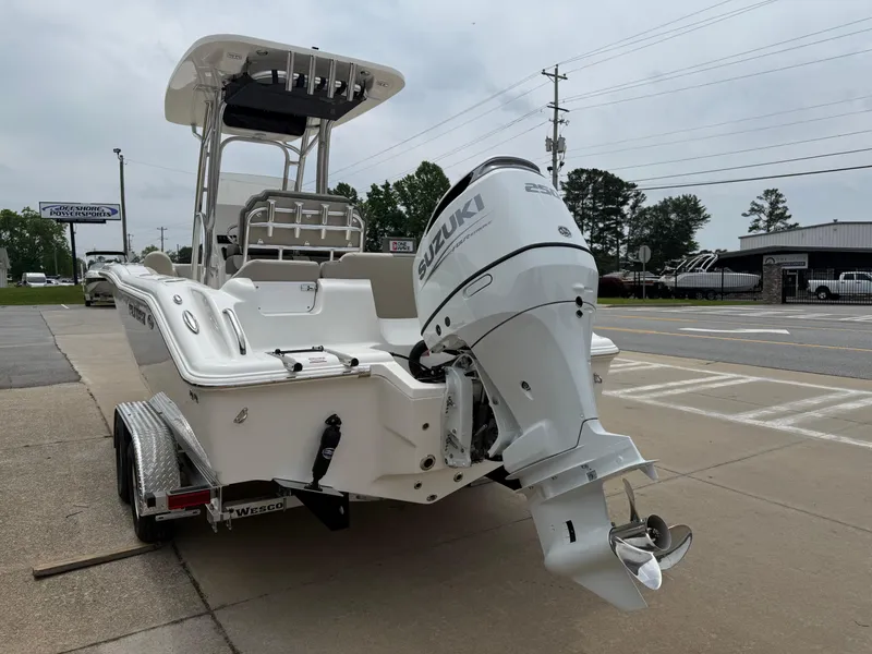 Slide: The Image of 2025 Key West 239 FS boat with Suzuki outboard motor on trailer, parked outdoors. - 5