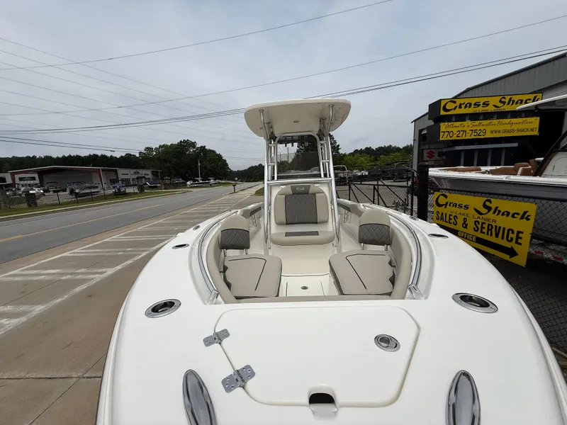 Slide: The Image of 2025 Key West 239 FS boat displayed at dealership, featuring spacious seating and modern design. - 7