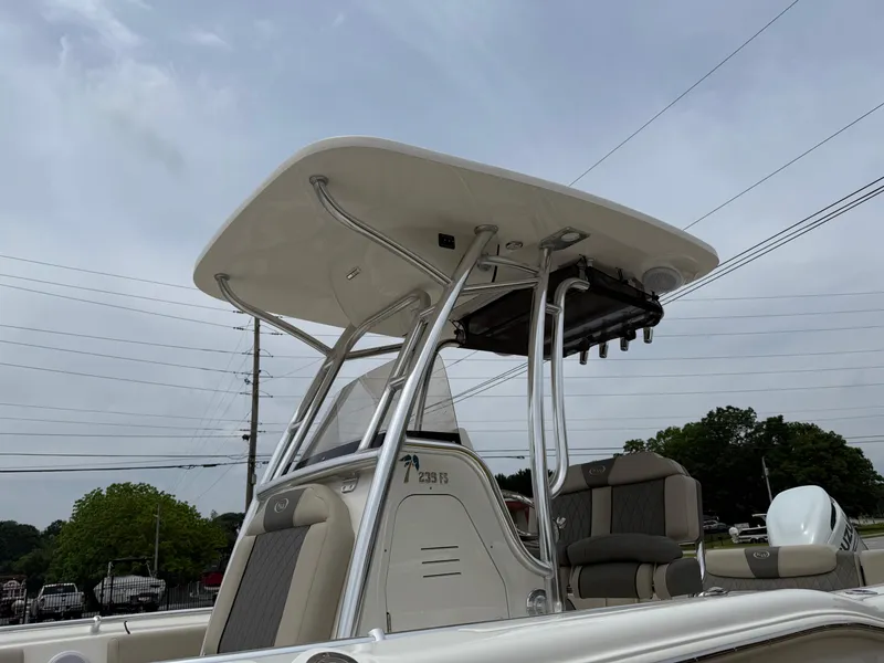 Slide: The Image of 2025 Key West 239 FS boat with T-top and seating, under cloudy sky. - 8