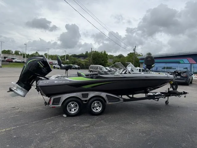 Slide: The Image of 2022 Ranger 212LS boat on trailer, parked outdoors under cloudy sky. - 7