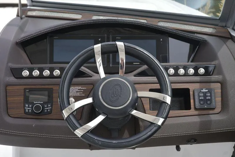 Slide: The Image of Steering wheel and dashboard of a 2017 Cobalt R7 boat. - 12