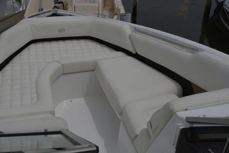 Slide: The Image of 2017 Cobalt R7 boat interior with white cushioned seating and sleek design. - 15