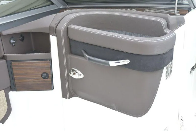 Slide: The Image of 2017 Cobalt R7 boat interior with sleek brown door and chrome handle. - 17