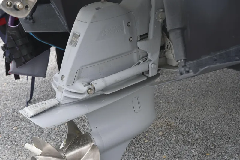 Slide: The Image of Close-up of a 2017 Cobalt R7 boat's outboard motor and propeller on gravel. - 22