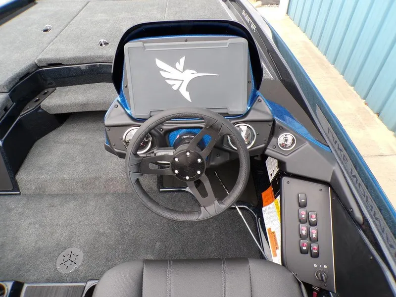 Slide: The Image of 2025 Skeeter ZXR21SE boat dashboard with steering wheel and control panel. - 17