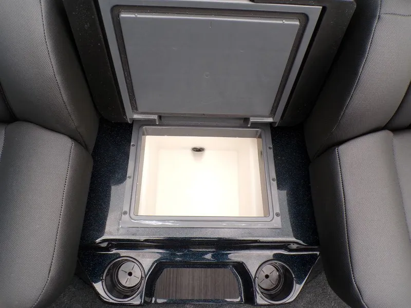 Slide: The Image of 2025 Skeeter ZXR21SE boat storage compartment with cup holders, open lid view. - 22