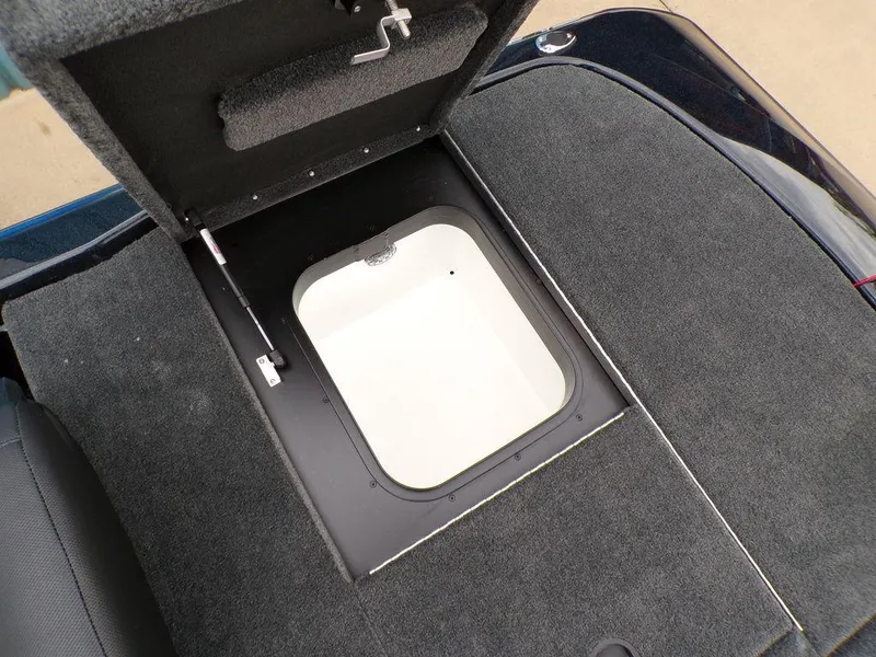 Slide: The Image of Storage compartment in 2025 Skeeter ZXR21SE boat, featuring carpeted interior and secure latch. - 23