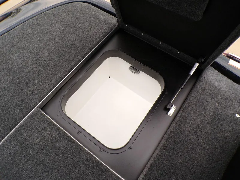 Slide: The Image of 2025 Skeeter ZXR21SE storage compartment with open hatch, featuring carpeted interior. - 24