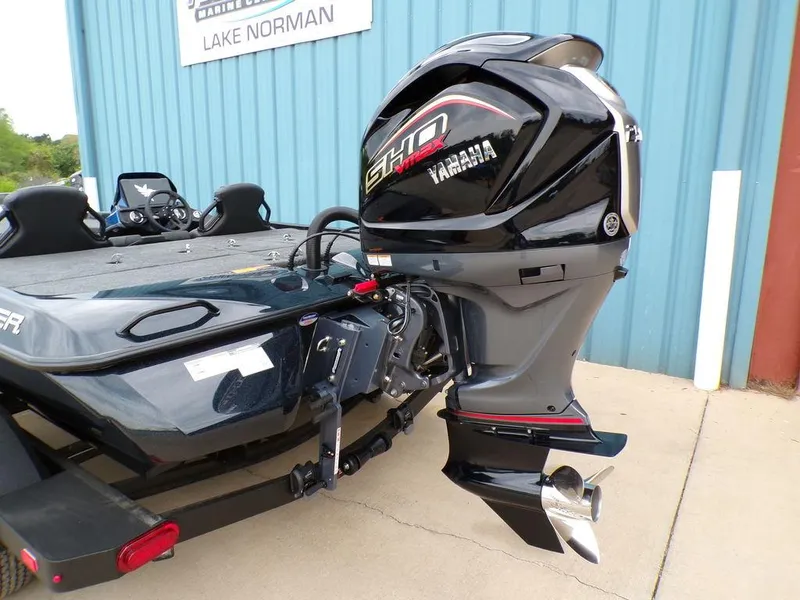Slide: The Image of 2025 Skeeter ZXR21SE boat with Yamaha outboard motor, parked near Lake Norman. - 6