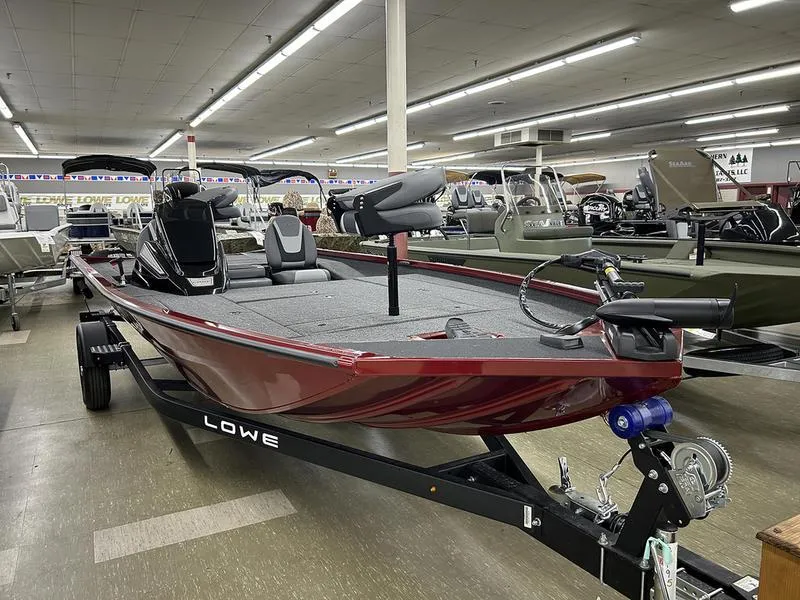 Slide: The Image of 2025 Lowe Stinger 195C boat in showroom, red exterior, spacious deck, modern seating. - 3