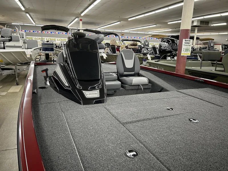 Slide: The Image of 2025 Lowe Stinger 195C boat displayed in showroom, featuring sleek design and comfortable seating. - 4