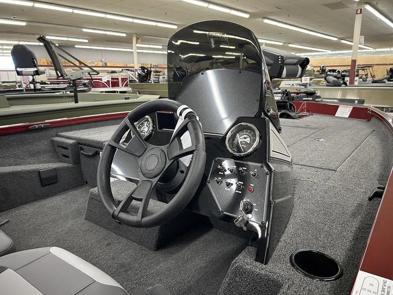 Slide: The Image of 2025 Lowe Stinger 195C boat interior with steering wheel and dashboard controls. - 6