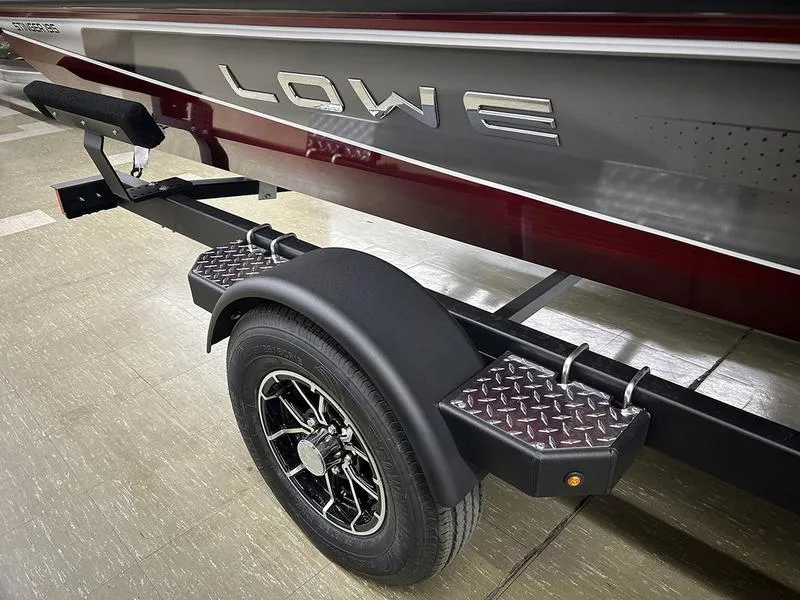 Slide: The Image of 2025 Lowe Stinger 195C boat trailer with diamond plate step and black wheel. - 7
