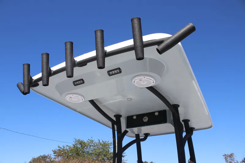 Slide: The Image of 2025 East Cape 25 Open boat T-top with rod holders against clear blue sky. - 10