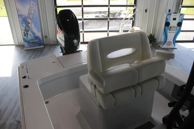 Slide: The Image of 2025 East Cape 25 Open boat interior with seating and motor in showroom. - 13