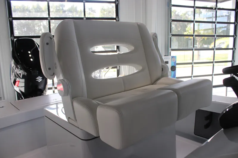 Slide: The Image of 2025 East Cape 25 Open boat seat in a showroom setting. - 16